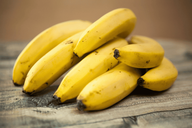 A group of bananas on a wooden table